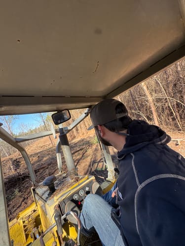 Customer operating heavy machinery in a wooded area, a use-case for the GS Extreme 3.0 hearing protection.