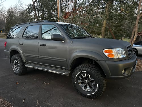 Customer's dark gray SUV with a wider, aggressive stance after installing the 1.25" Hubcentric Wheel Spacers.