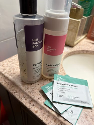 Reviewer's Everywhere Wipes in convenient travel packets displayed on a bathroom counter with other products.