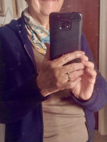 Partial view of a reviewer wearing the taupe Hannah Long Sleeve Top as a base layer under a zip-up hoodie.