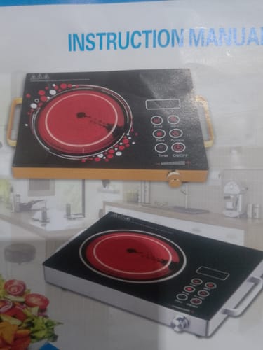 Customer photo of the instruction manual for the RAF Infrared Electric Stove, showing two product designs.