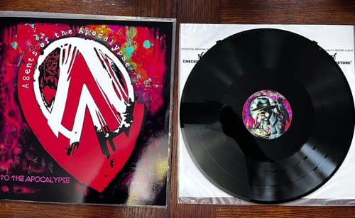 Customer's custom vinyl record and sleeve. The sleeve has a red logo and the record's center has a custom image.