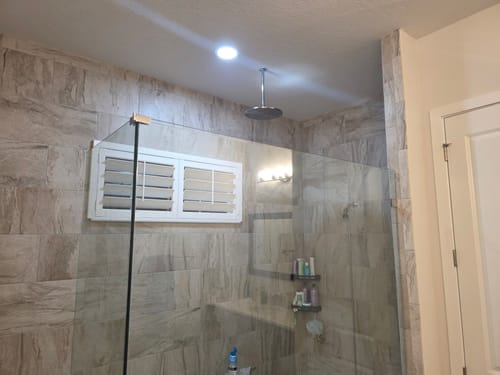 Customer's 12 Inch Rain Shower Head installed from the ceiling in a modern tiled walk-in shower.