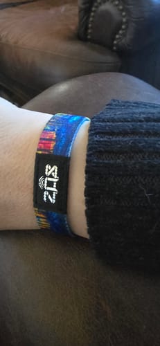 Reviewer wearing the colorful 'Comparison Is The Thief Of Joy' bracelet on their wrist.