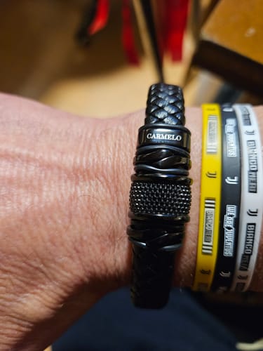 Close-up of a customer wearing the personalized black bracelet on their wrist.