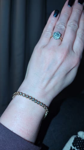 A reviewer wearing the Classic Bezel Tennis Bracelet, showing its fit on their wrist.