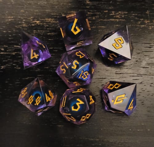 Customer's translucent purple Omnipotent Liquid Core Dice Set, showing the floating eyeball feature on a dark wood surface.