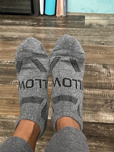 Reviewer wearing the grey Men's Alpaca Socks, seen from a first-person perspective.