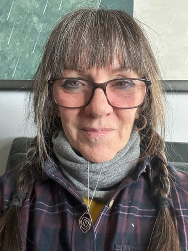 Reviewer wearing the snug grey winter neckerchief to keep her neck warm.