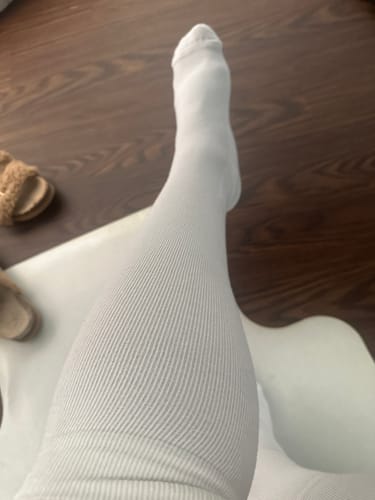 Reviewer showing the fit of their white, ribbed Performance Eucalyptus Compression Socks.