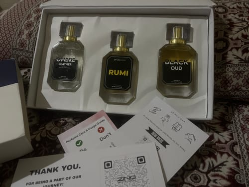 Customer's OUD Supreme BUNDLE unboxed, showing three different perfume bottles inside the white packaging.