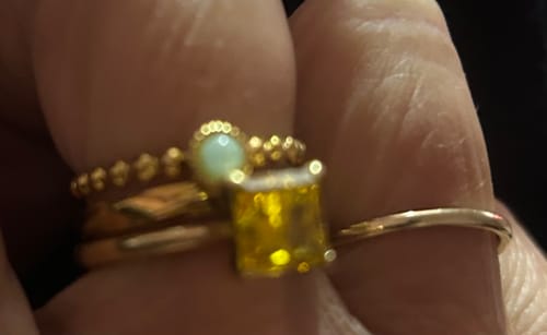 Close-up: A customer's hand showing the two bands of the gold-colored Double Layer Stone Ring.