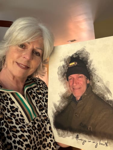 Customer holding her personalized photo painting, which features a watercolor-style portrait of a man.