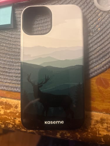 Reviewer's Mystery Alphaproduct case showing a deer silhouette against a scenic mountain background.