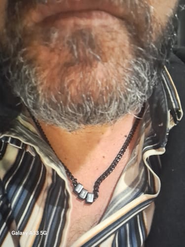 Close-up of a reviewer wearing the Legacy necklace with silver beads on a black chain.