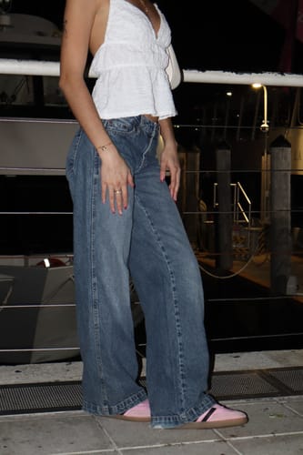 Reviewer showing their Forever Love Heart Bracelet as part of a casual outfit with jeans and a white top.