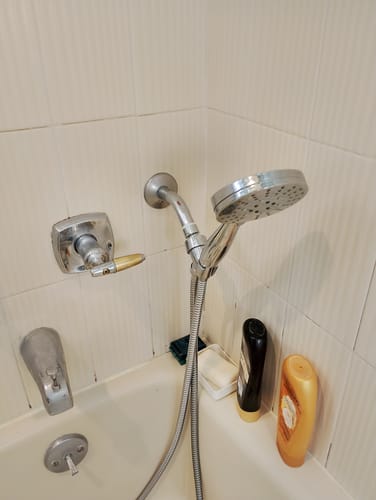 Reviewer's sturdy, metal 3-Spray Handheld Shower Head Set installed in their shower.