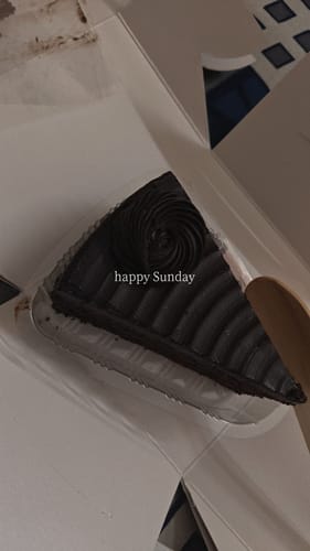 Customer's close-up of a dark chocolate pastry from the Pastry Pack inside a white box.