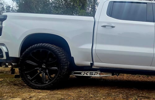 Customer's Traction Bar Stainless Steel Plate with a KSP logo installed on the side of a white truck.