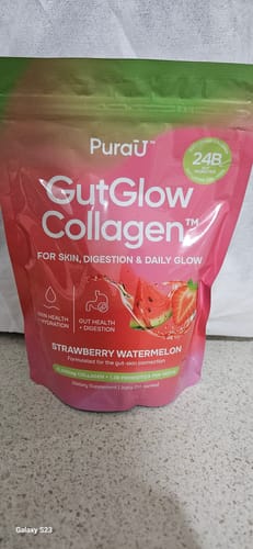 A customer's pink and green pouch of GutGlow Collagen in the Strawberry Watermelon flavor.
