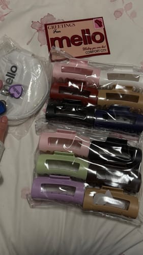 Customer displays multiple colorful cloud clips in clear packaging next to a branded pouch and card.