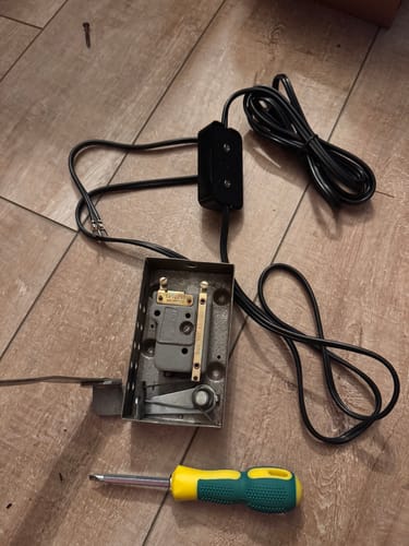 Reviewer showing the new Power Cord and Motor Block during installation in a vintage sewing machine.