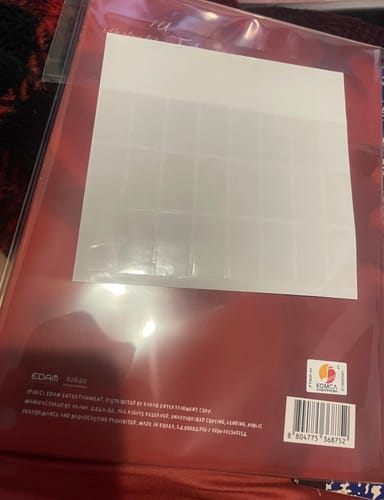 Customer showing a sheet of the clear sticky tabs placed on a red album in a protective sleeve.