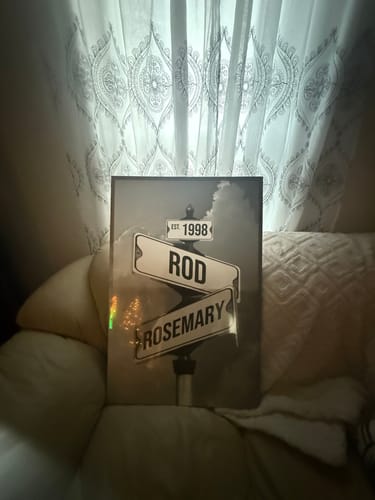 Customer's personalized street sign canvas with the names 'Rod' and 'Rosemary' and the year 'Est. 1998' displayed in their home.