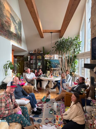 Reviewer's living room with a tall, healthy dracaena and other plants, an 'after' photo showing Plant Food results.