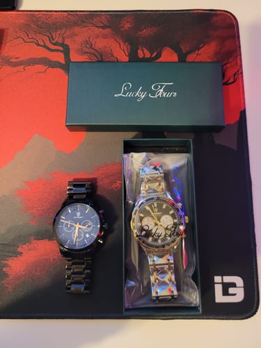 Customer's two Lucky Fours® Ronin watches, a black one and a two-tone one in its packaging.