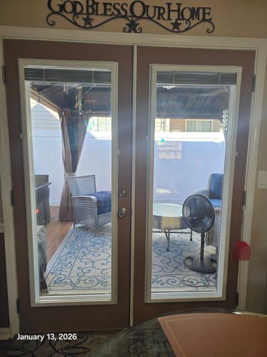 Customer's Clear 1 Lite Glass and Frame Kit installed on a pair of brown doors leading outside to a patio.
