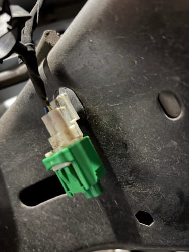Close-up of a customer's green and white plug from the Tuner Harness Plug Kit installed on a Ram Cummins.