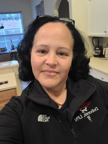 Reviewer wearing their black The North Face Apex Barrier Soft Shell Jacket with custom embroidery on the chest.