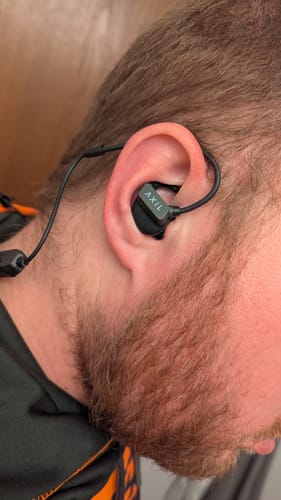 Customer wearing the black GS Extreme 3.0 hearing protection, showing the secure fit in their ear.