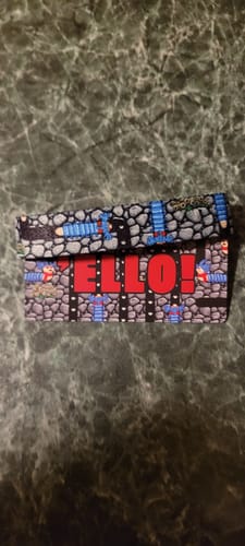 Customer's Ello Bracelet laid flat, showing the stone maze design and the red text 'ELLO!'.