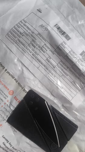 Customer showing the single Folding Card Tool they received, with its shipping packaging.