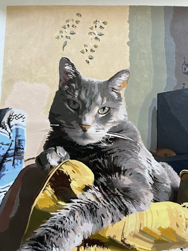 Customer's completed Paint Your Pet by Numbers portrait of a grey cat resting on a yellow chair.