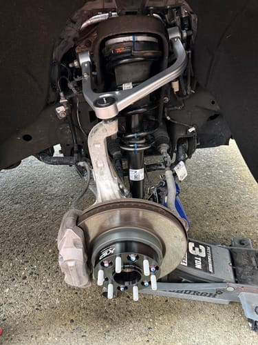 Customer's close-up showing a black 1.5" hubcentric wheel spacer installed on a truck's wheel hub assembly.