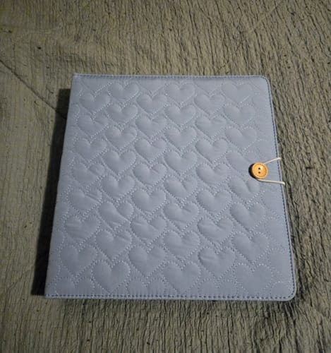 Customer's light blue Cupid's Collection A5 binder, featuring a quilted heart pattern and a button closure.