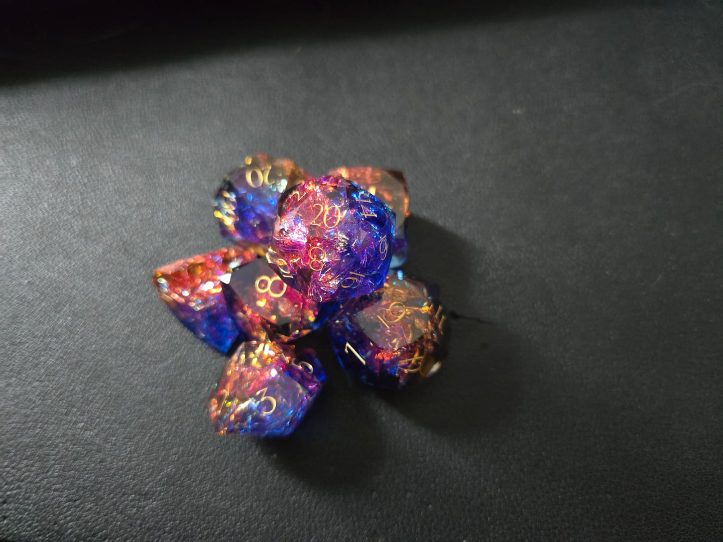 Customer photo review of URWizards D&D Resin Cosmic Burn Engraved Dice Set Multi-faceted Style