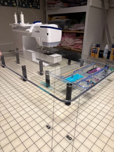 Customer's clear Wish Extension Table 2.0 fitted to a sewing machine on a gridded mat, showing the expanded work surface.