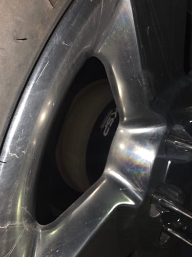 Close-up of a customer's black 2-inch wheel spacer installed behind a shiny chrome wheel.