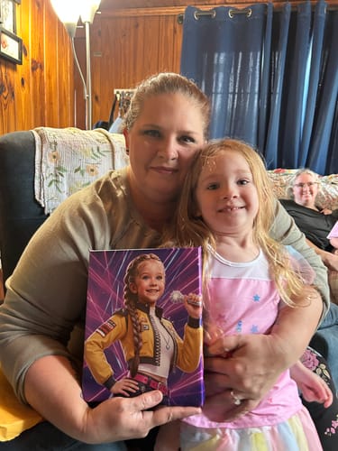 Customer holds their K-Pop Queen The Magic Beats portrait while hugging a smiling child.