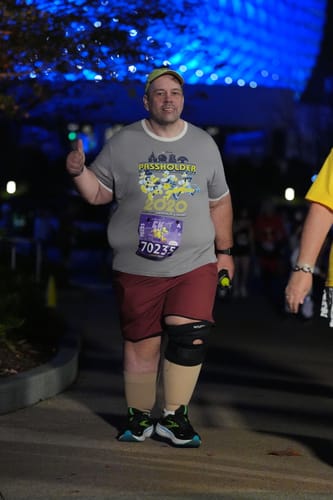 Reviewer smiling in brick-colored V2 Lined Training Shorts while participating in a nighttime race.
