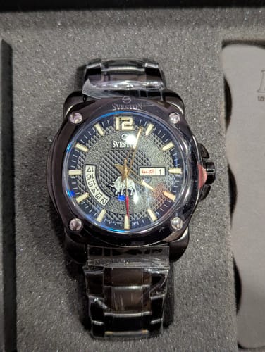 Customer's black Bullston watch with a textured dial, shown inside its packaging.