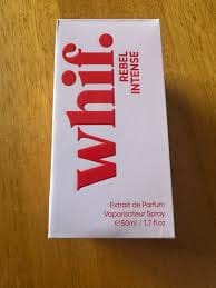 Customer's white box for Rebel Intense perfume standing on a wooden surface.