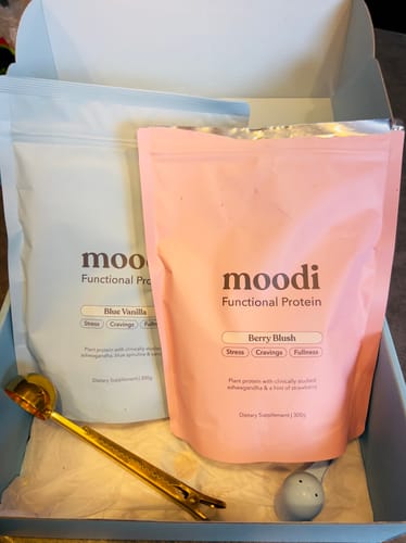 Reviewer's unboxed Classic Protein Bundle, showing the Blue Vanilla and Berry Blush protein pouches inside.