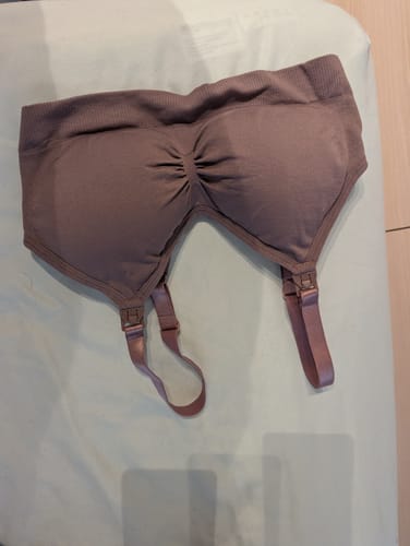 A customer's mauve Lovemère Seamless Nursing Bra from the starter kit, laid flat on a bed.