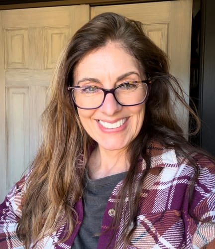 Reviewer smiling while showing her bright, natural-looking Pop On Veneers.