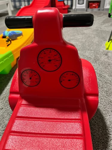 Customer's three gauge speed cluster vinyl decals applied to the dashboard of a red plastic ride-on toy.
